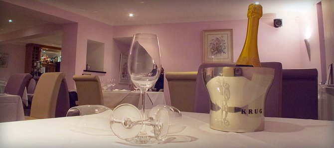 The dining room is chic, featuring lilac walls The dining room is chic, featuring lilac walls